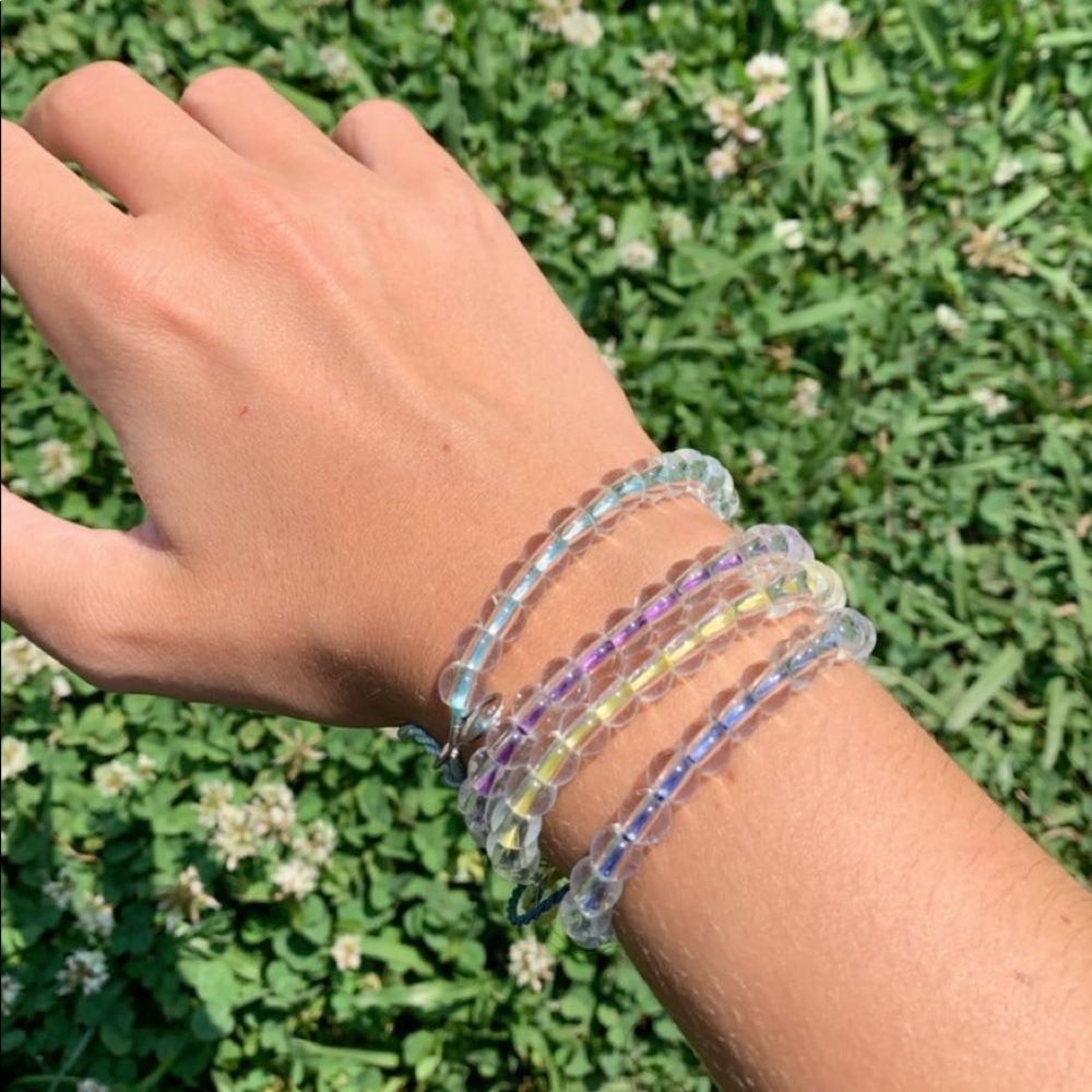 noahkade0629 4ocean bracelets in yellow and purple